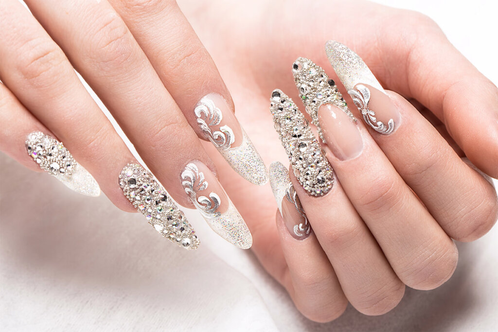 Beautifil wedding manicure for the bride in gentle tones with rhinestone. Nail Design. Close up