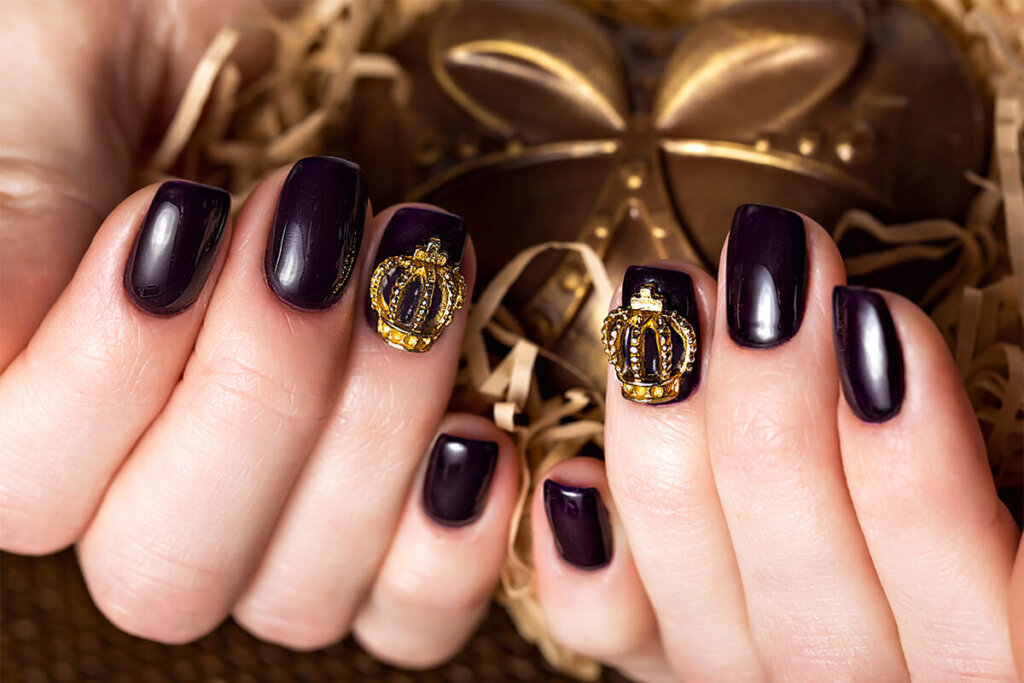 Black female manicure nails closeup with crown