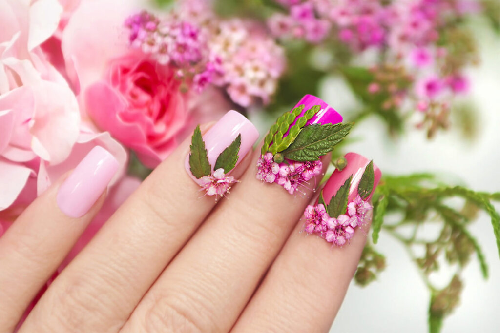 a hand with painted nails and flowers