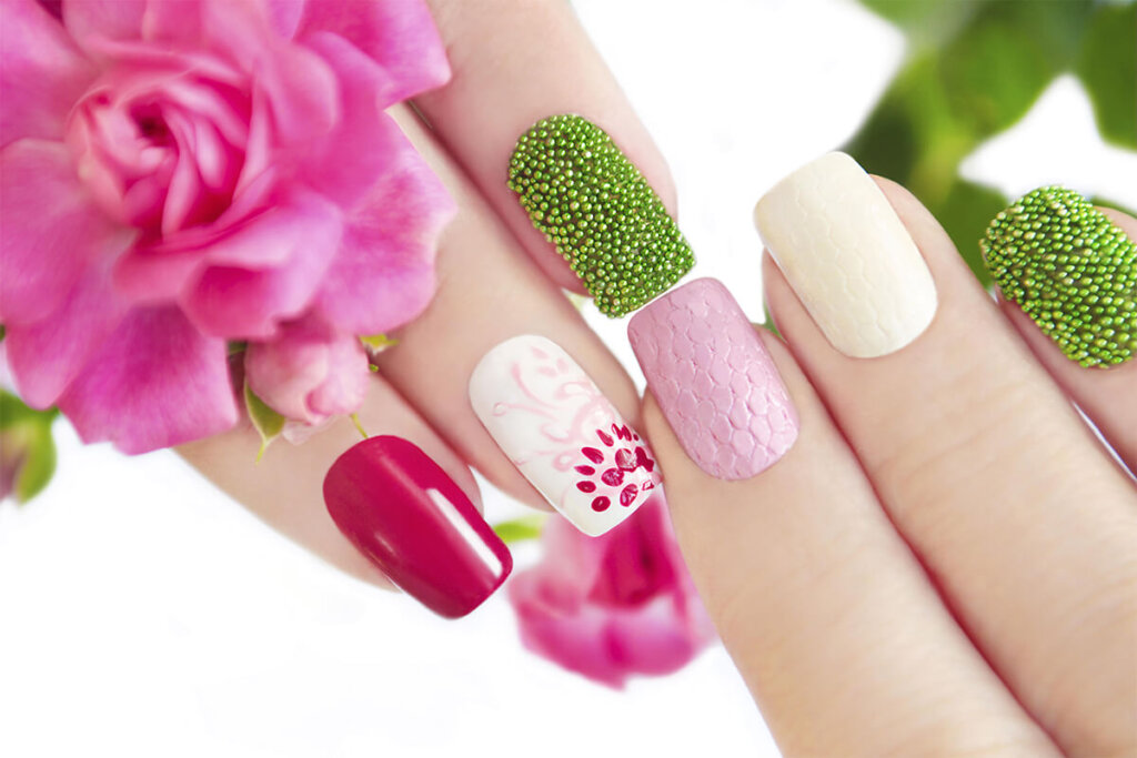 a close up of multicolored nails with flower