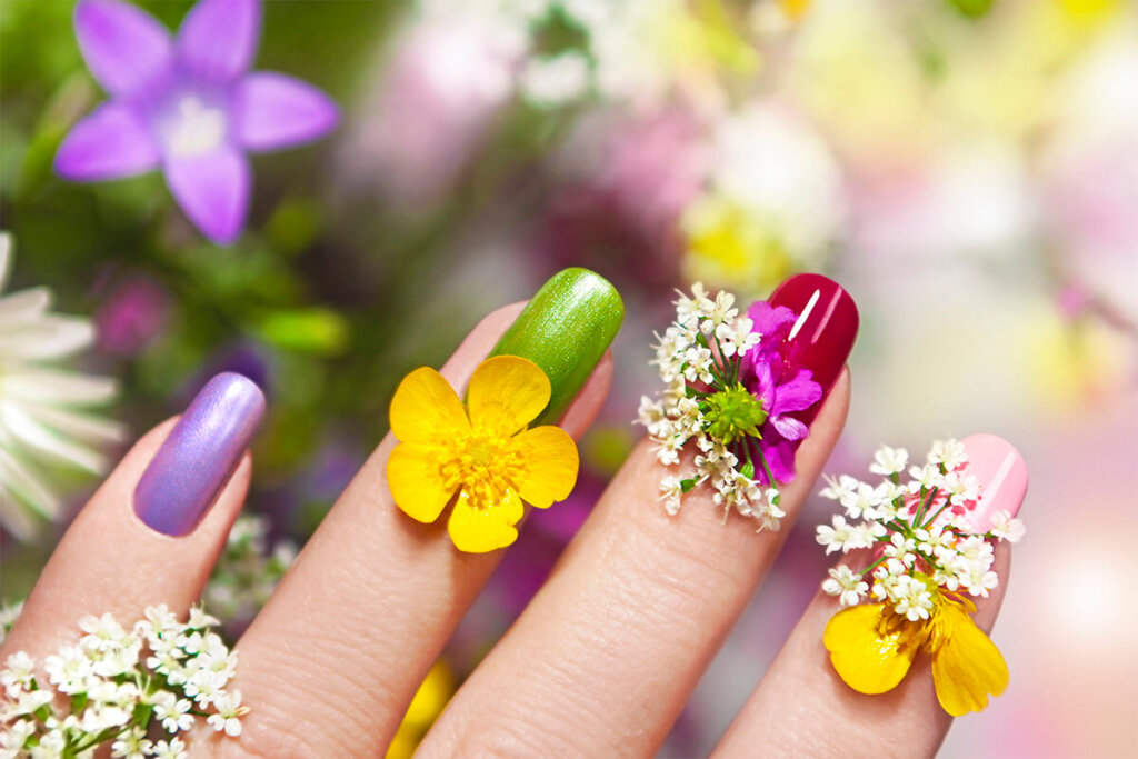 a close up of fingers with flowers on them